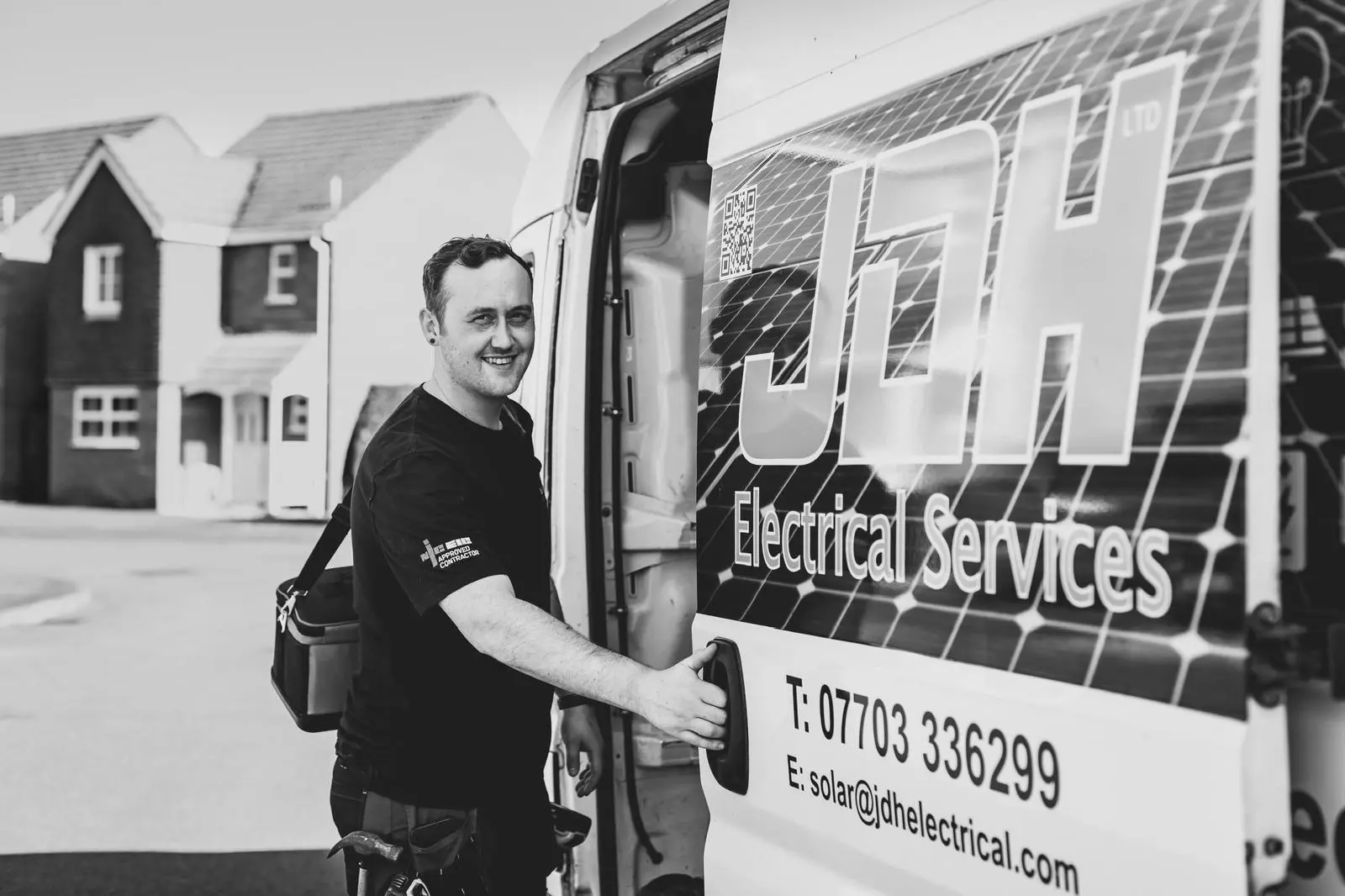 JDH Electrical engineer beside a branded service vehicle