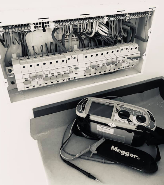 Electrical consumer unit and Megger test equipment used during inspection and testing