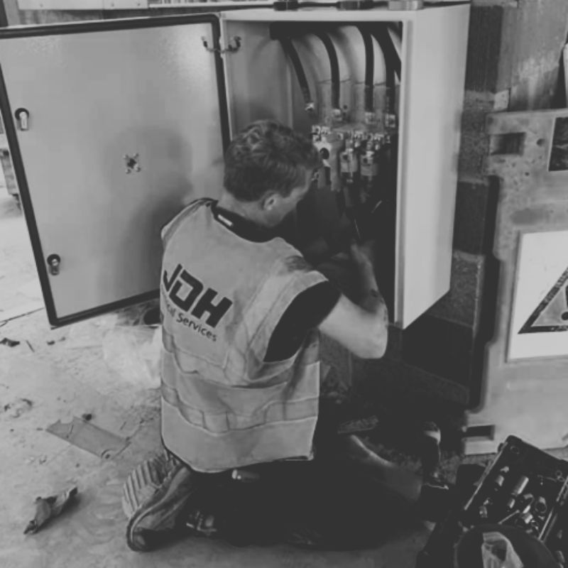 JDH Electrical engineer beside a branded service vehicle