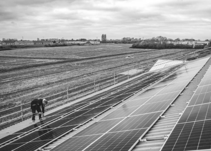 JDH team installing solar PV panels on a commercial roof